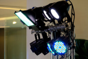 A stand of lights available for rental providing illumination in front of a building.
