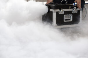 A smoke machine emitting clouds from a rental box.